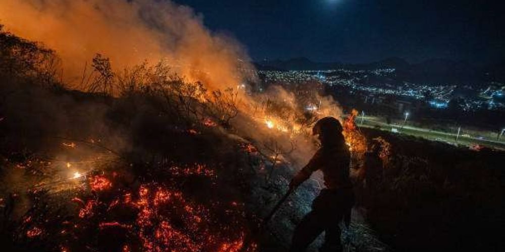 BOGOTA, COLOMBIA - JANUARY 24: Rescuers work to extinguis a forest fire near the "Doña Juana" dump on January 24, 2024 in Bogota, Colombia. Over twenty forest fires were registered in Bogota and several regions of Colombia amid high temperature records due to the El Niño phenomenon. (Photo by Diego Cuevas/Getty Images)